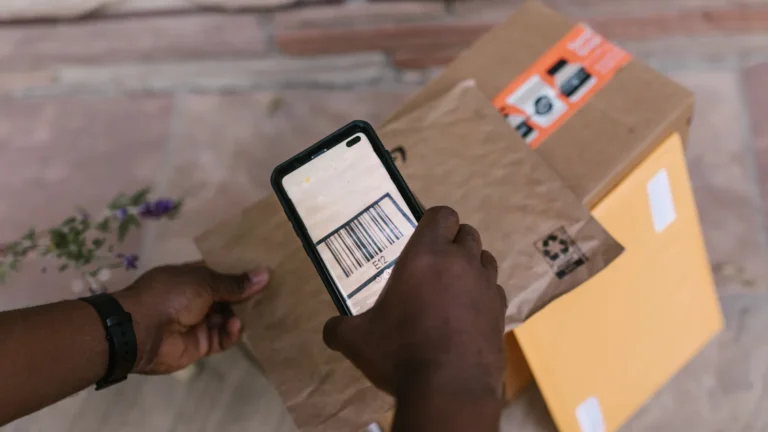 Person scanning a parcel barcode with a smartphone to check a tracking number